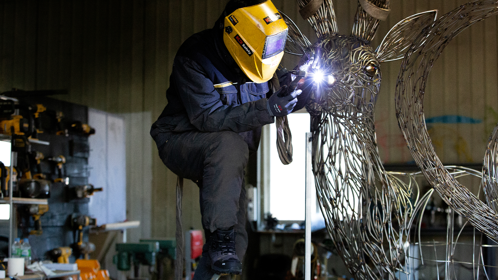 Artist welding a sculpture in K2 safety boots